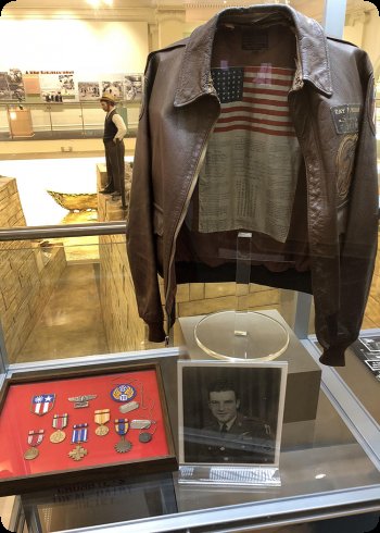 Image of jacket, metals, and photograph of Joliet native Ray Keenan was drafted into WWII. He was a nose gunner and bombardier in the 9th Bomb Squadron, 7th Bomb Group.