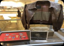 Image of jacket, metals, and photograph of Joliet native Ray Keenan was drafted into WWII. He was a nose gunner and bombardier in the 9th Bomb Squadron, 7th Bomb Group.