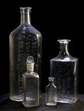 Image of Clarkson Pharmaceutical bottles. (shows tall Clarkson bottle back left and small version front right) 